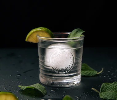 Vodka with lime and ice in a serving glass